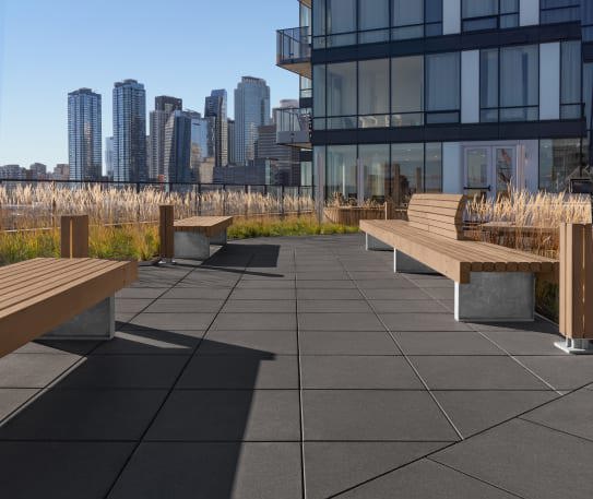 Techo-Bloc&#x27;s sleek commercial Industria paver installed on the rooftop courtyard of Le Duke Condos in Montreal.