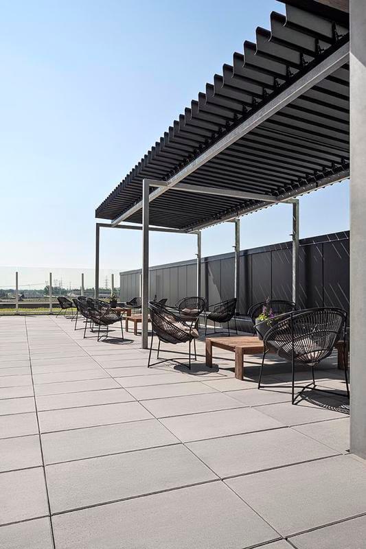 Seating area on the Devimco Rooftop in Montreal featuring Techo-Bloc Blu 60 Smooth Slab in Greyed Nickel.