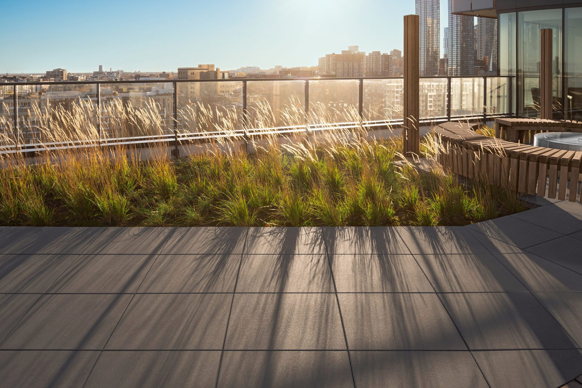 Rooftop of Le Duke Condos with a view of the city skyline featuring Techo-Bloc Industria Smooth Slab in Onyx Black.